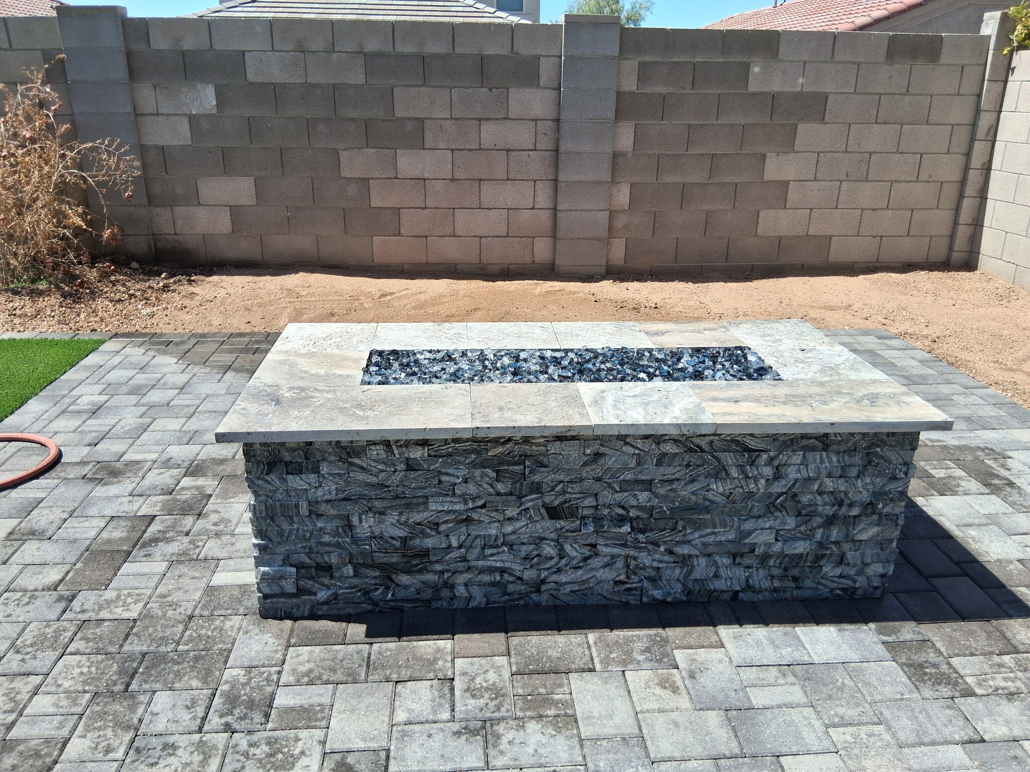 Fire pit feature set into a paver hardscape area