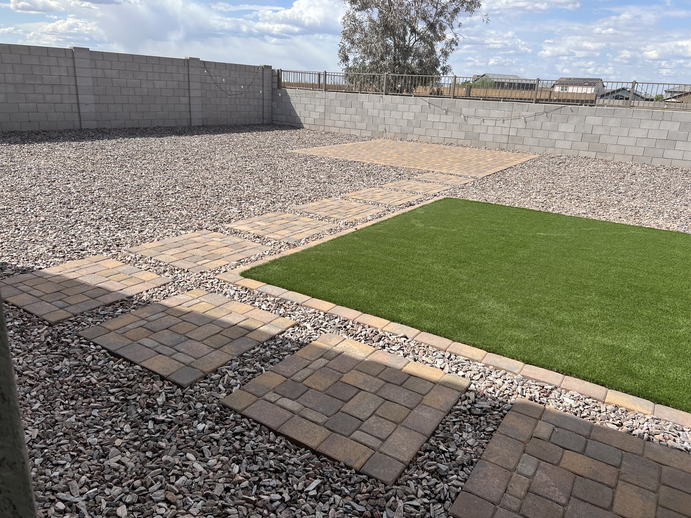 Small patio with a clean turf accent